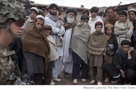 Afghan villagers listen to a soldier of the U.S. Army Easy Company, Second Battalion, 506th Infantry Regiment of the 101st Airborne Division during a joint operation with Afghan security forces in Naka, Paktika Province, Afghanistan, April 12, 2011. While fighting across Afghanistan usually increases each year with the spring thaw, Pentagon and military officials say that insurgent leaders are expected to make a major effort in coming days. (Mauricio Lima/The New York Times)